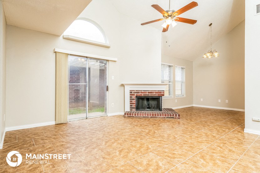 a living room with a fireplace and a sliding glass door