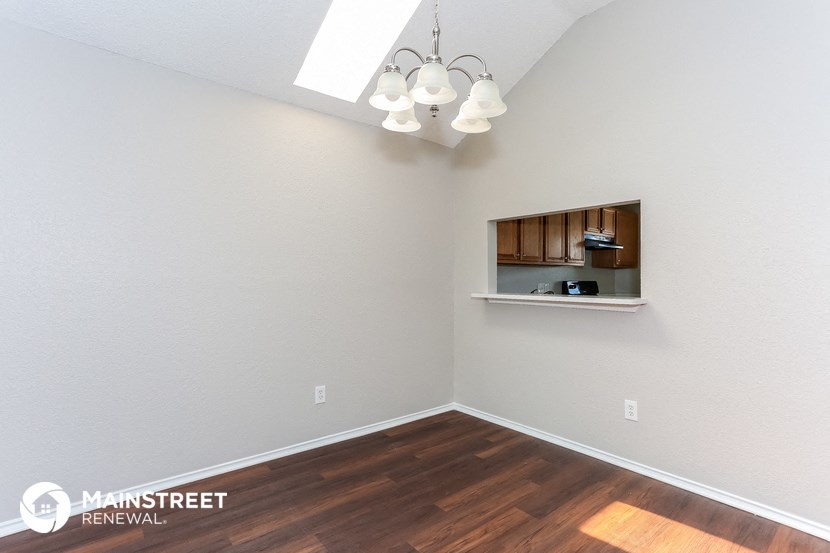 a living room with a hard wood floor and a window