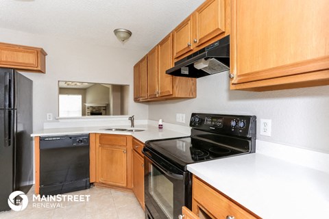 a kitchen with black appliances and wooden cabinets