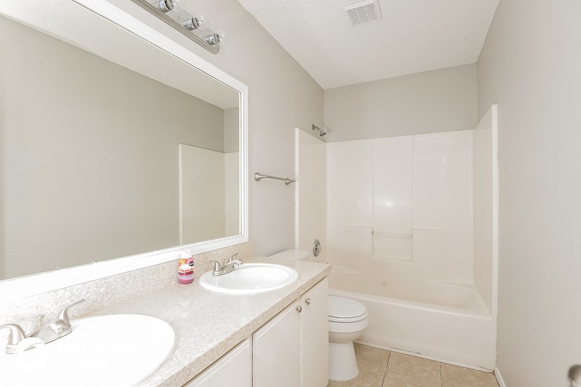 a bathroom with a sink and a toilet and a mirror