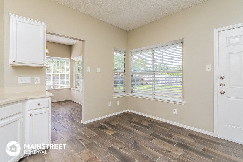 the living room and dining room of a house with a large window