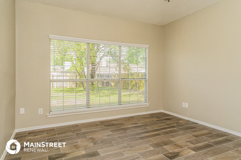 the living room of an empty house with a large window