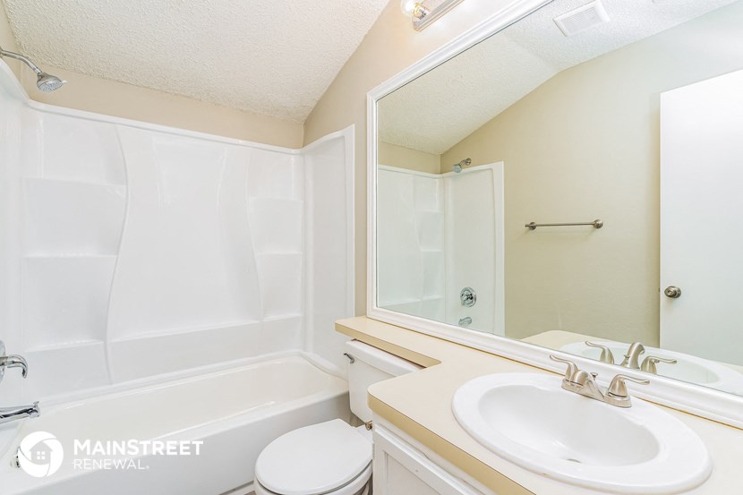 a bathroom with a sink and a toilet and a bath tub