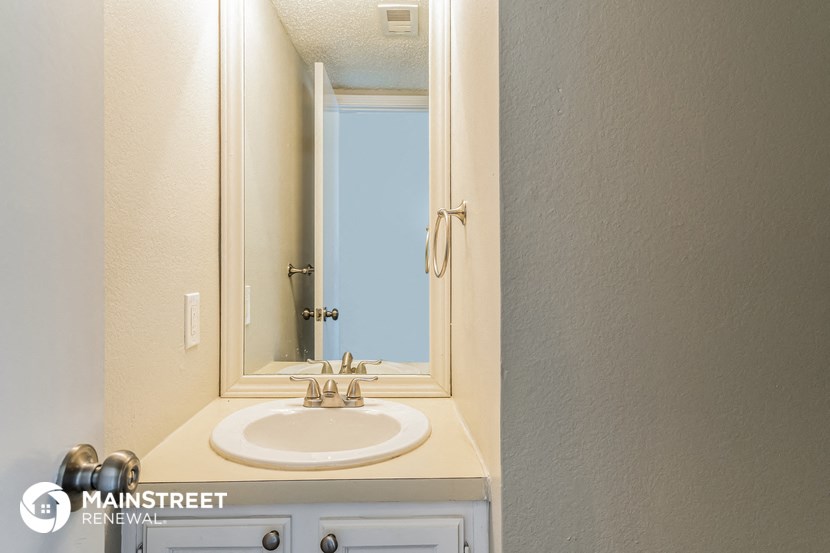 a small bathroom with a sink and a mirror