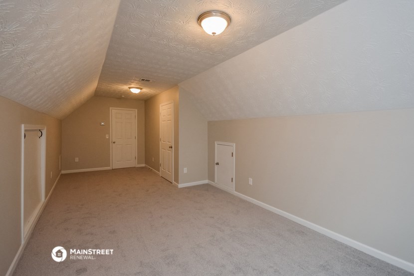 the spacious living room with a door into the dining room