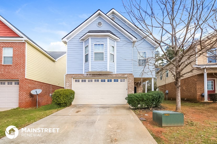 a blue house with a white garage door