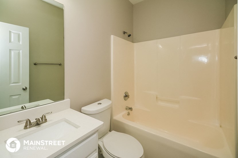 a bathroom with a tub and a sink and a toilet