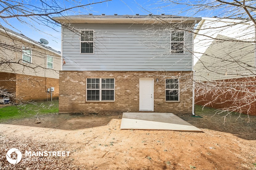 the front of a brick house with a white door