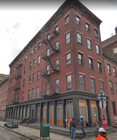 A group of people are standing outside of a building.