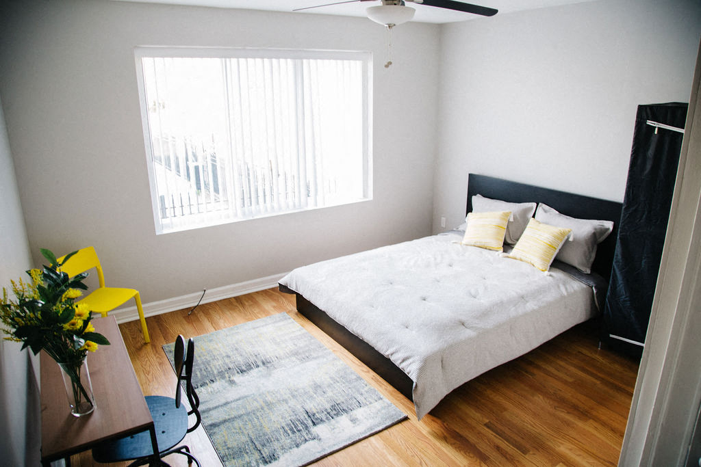 a bedroom with a bed and a window