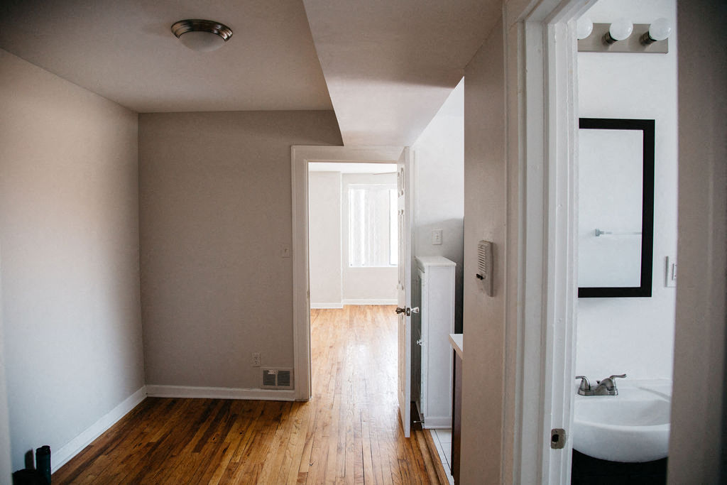 a hallway with a sink and a mirror      and a door