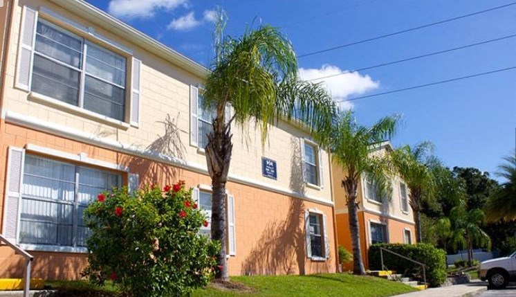 a building with palm trees in front of it