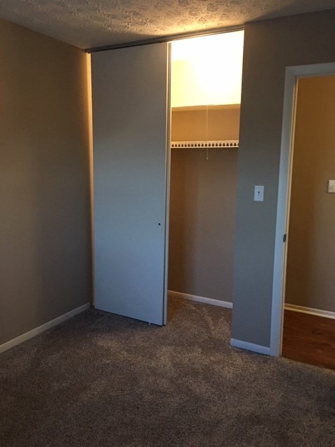 a room with a closet and a mirror in it