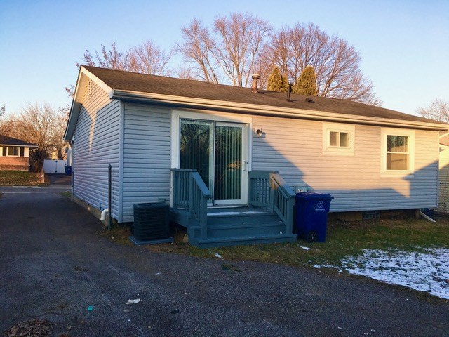 a small house with a porch and stairs