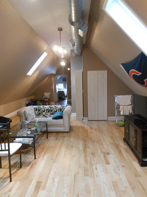 a living room with a hard wood floor and a couch and a table