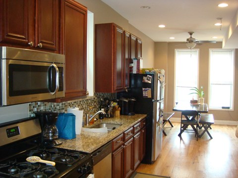 a kitchen with stainless steel appliances and wooden cabinets