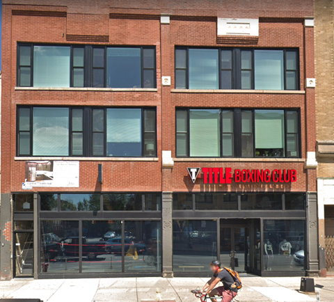 a man riding a bike in front of a building