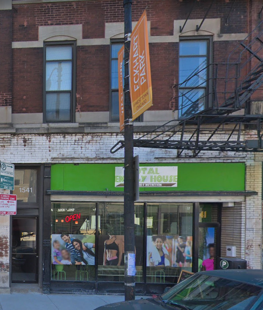 A building with a green awning and a sign that says "FASHION SALON".