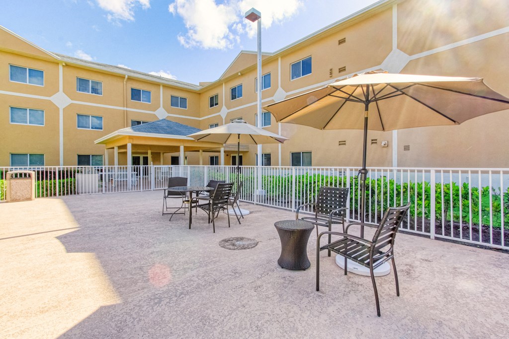 large sundeck with picnic tables and umbrellas