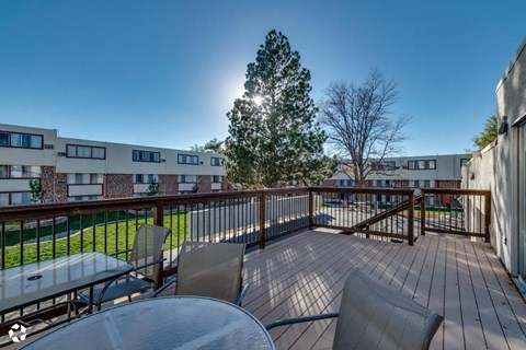 a patio with a table and chairs on a balcony
