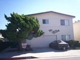 A house with a car parked in front.