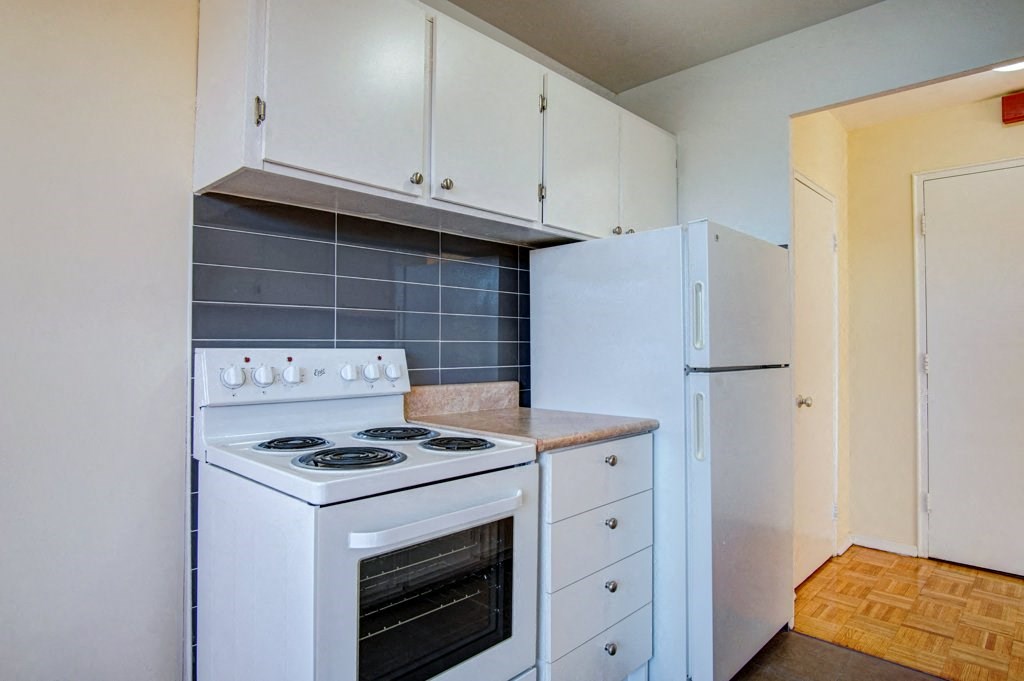 a kitchen with a stove and a refrigerator