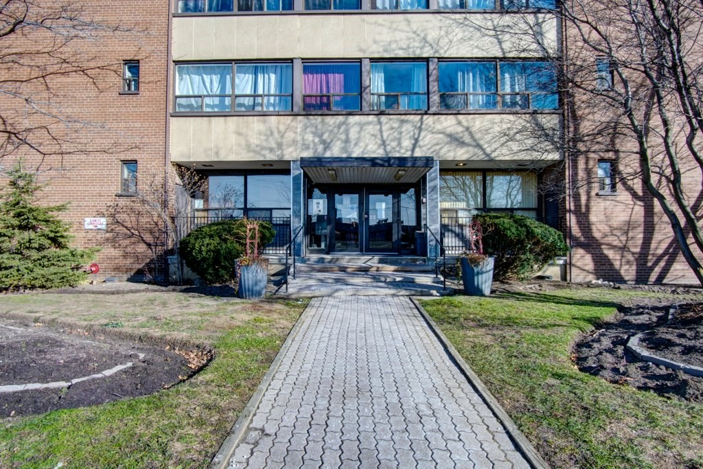 a brick building with a walkway in front of it