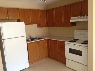 a kitchen with a stove refrigerator and a sink