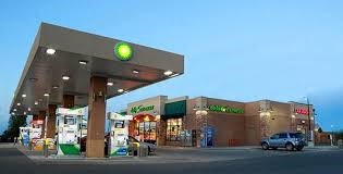 a gas station with a car parked in front of it