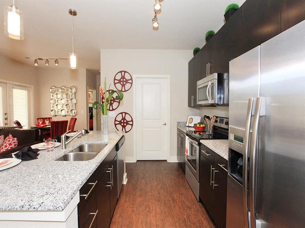 a kitchen with stainless steel appliances and granite counter tops