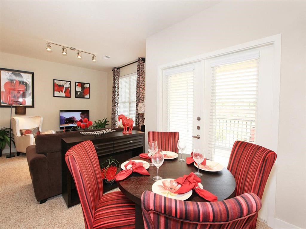 a dining room with a table and chairs