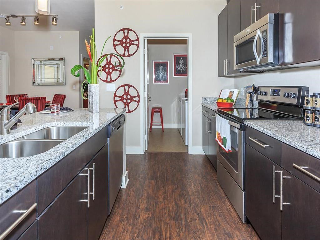a kitchen with stainless steel appliances and granite counter tops