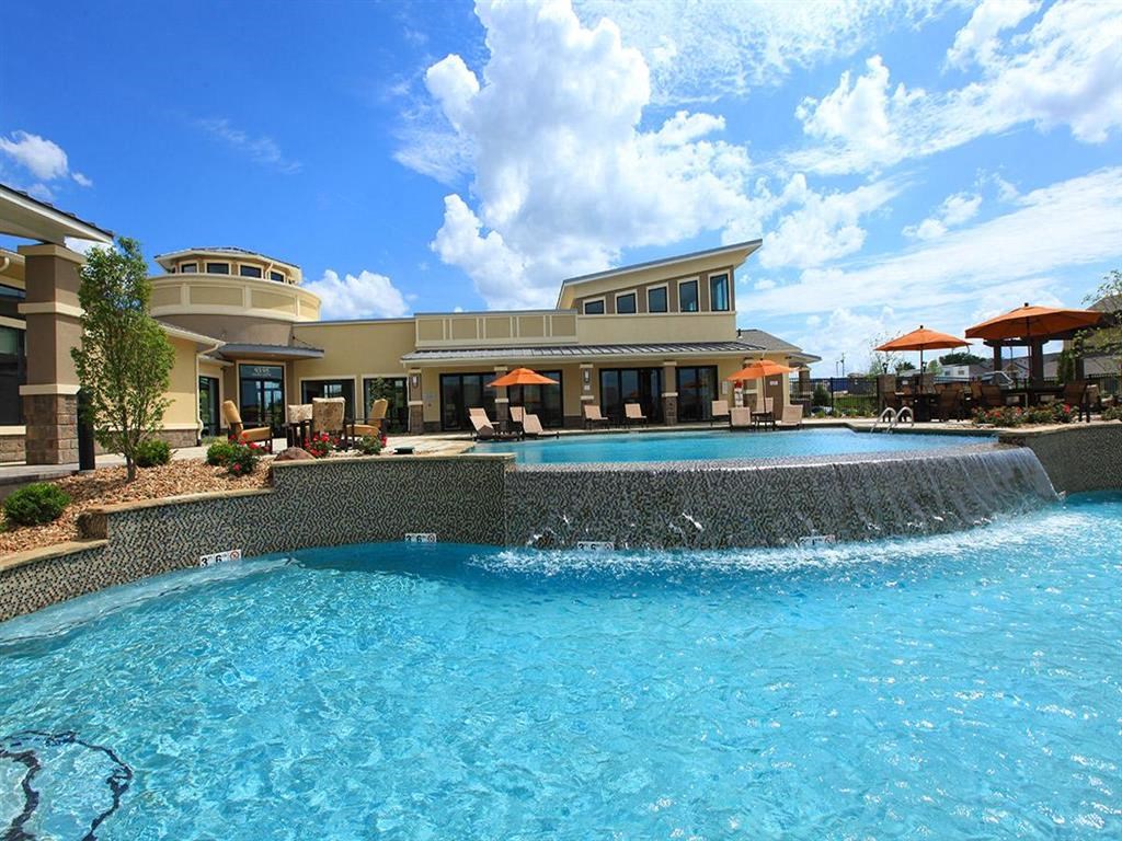 a large swimming pool with a building in the background