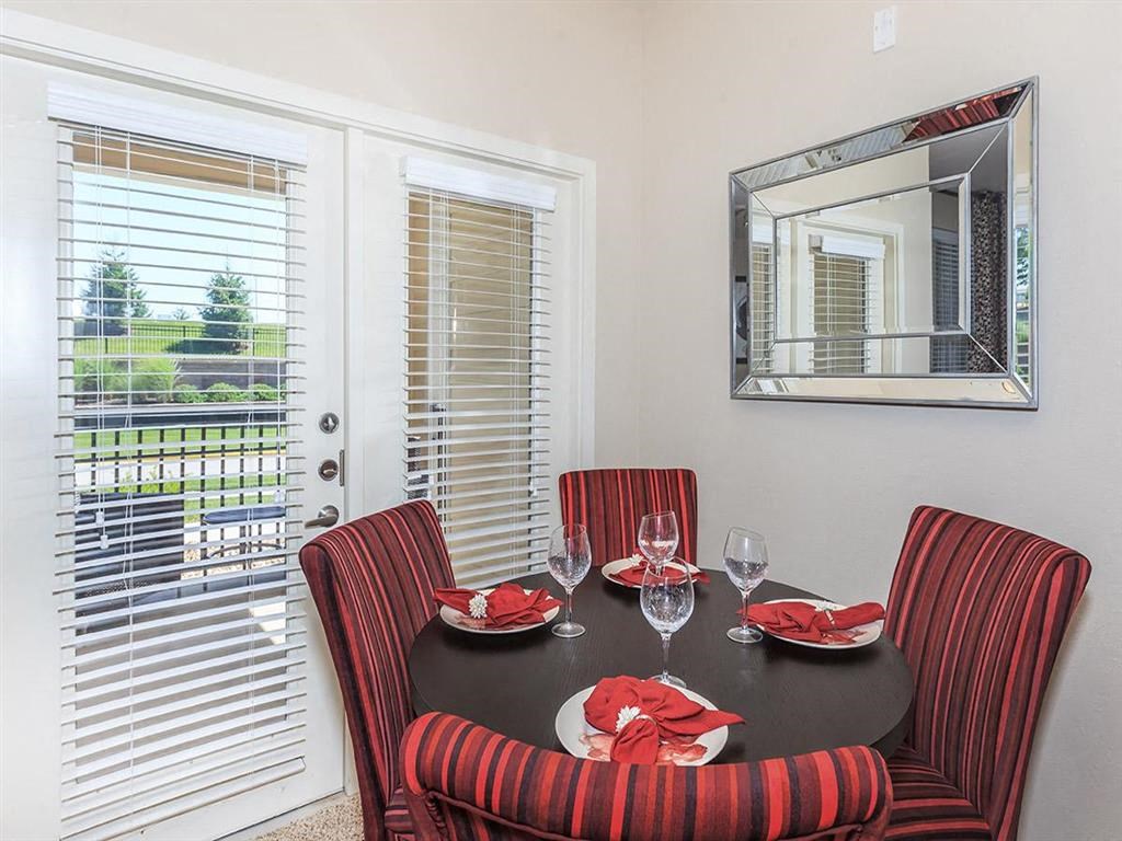 a dining room with a table and chairs