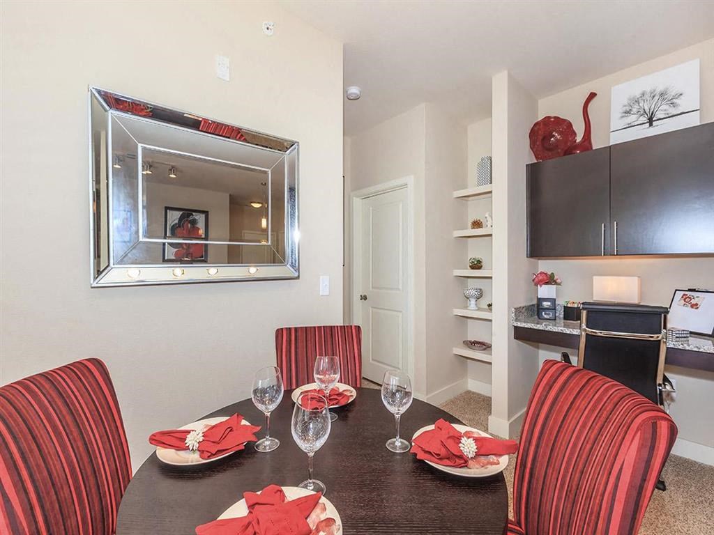 a dining room with a table and chairs