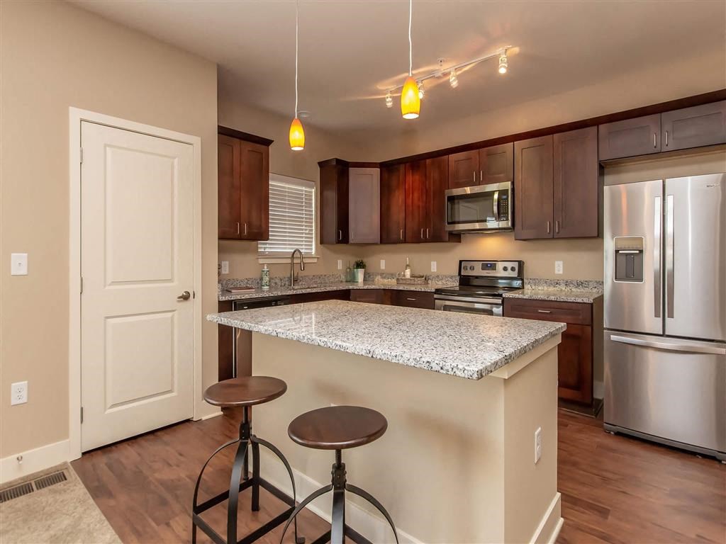 a kitchen with a counter top and a refrigerator