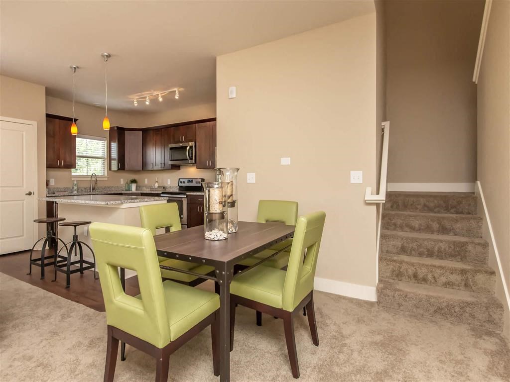 a dining room with a table and chairs