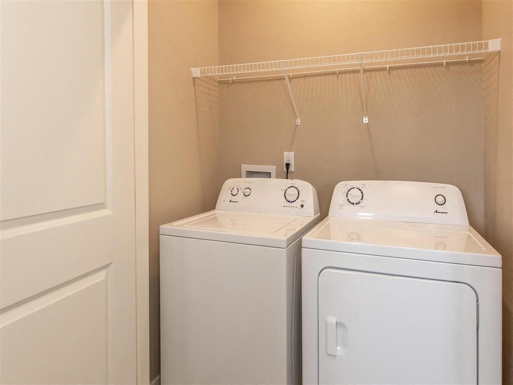 a laundry room with two washes and a dryer in it
