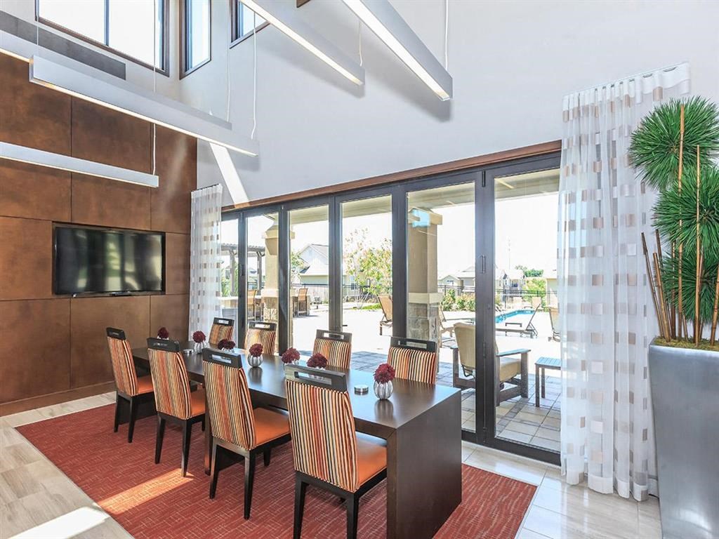 a dining room with a table and chairs and sliding glass doors