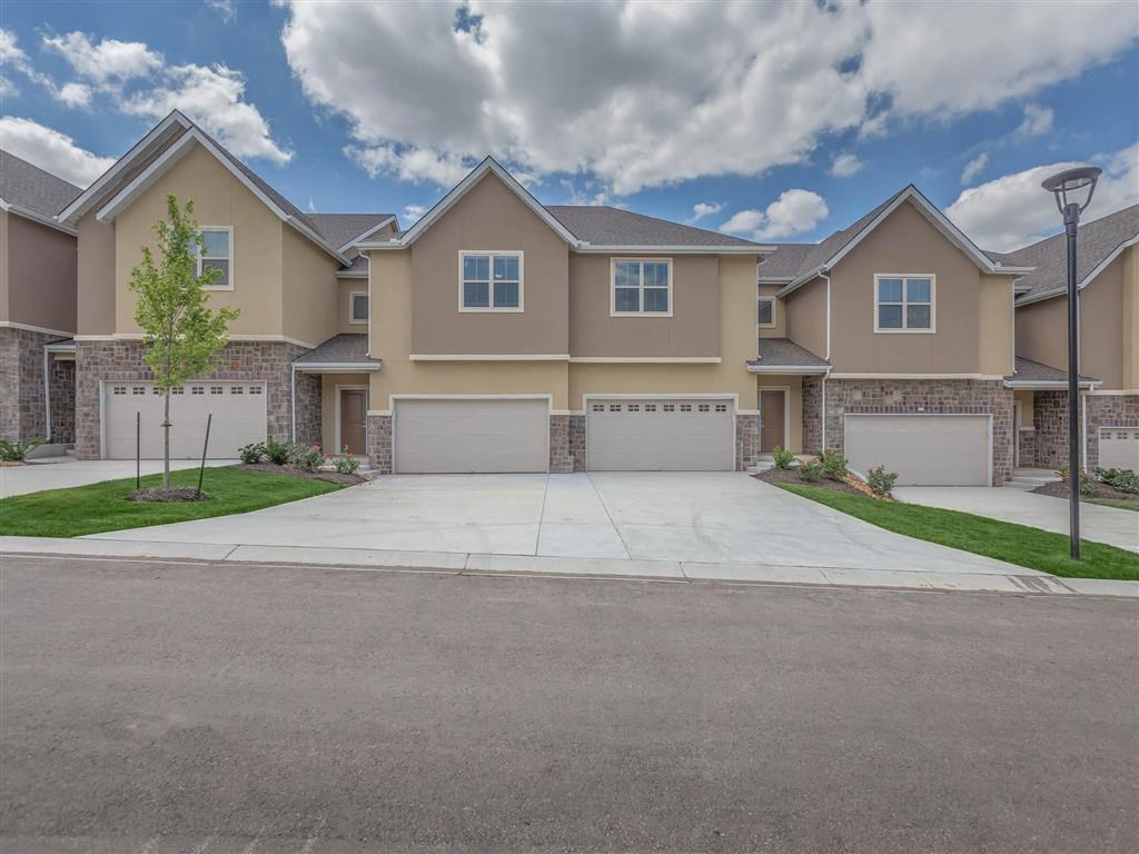 an empty driveway in front of a house
