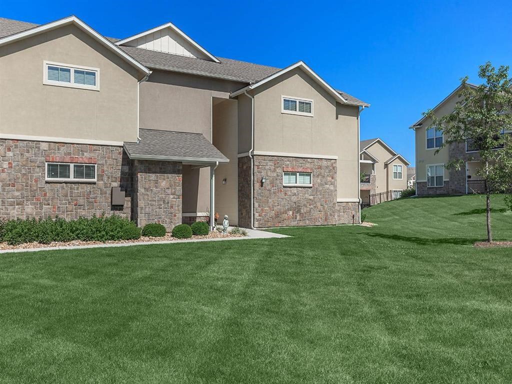 a lawn in front of an apartment building