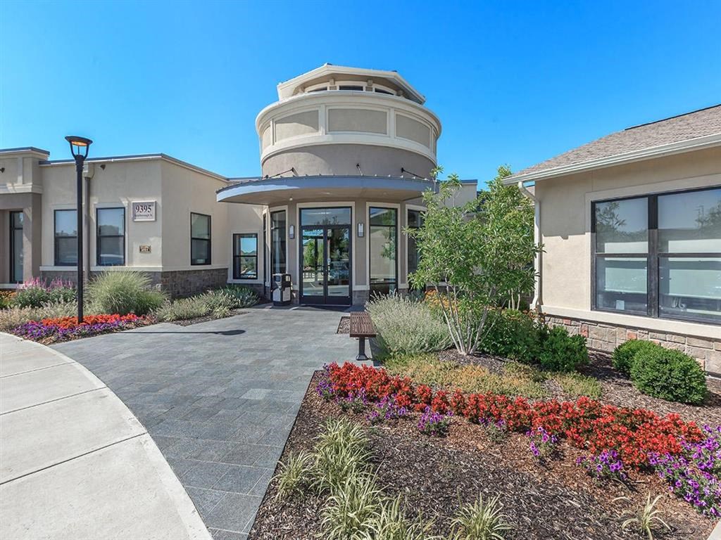 the front entrance of a building with a circular structure on top of it