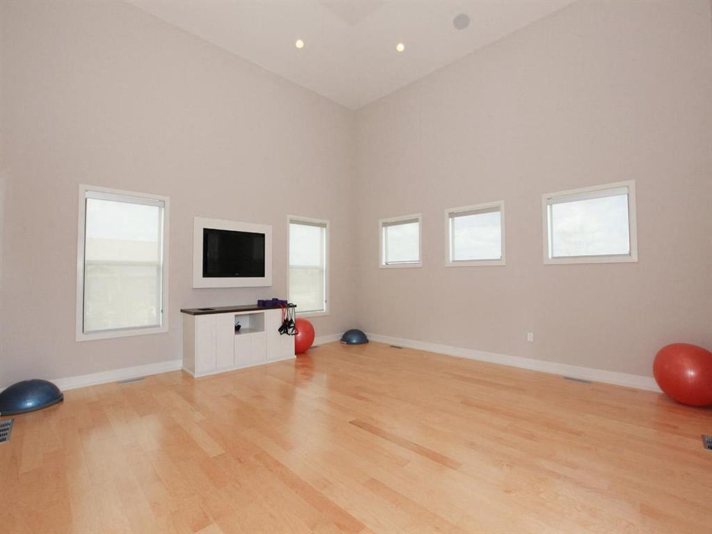 a living room with a tv and a hard wood floor