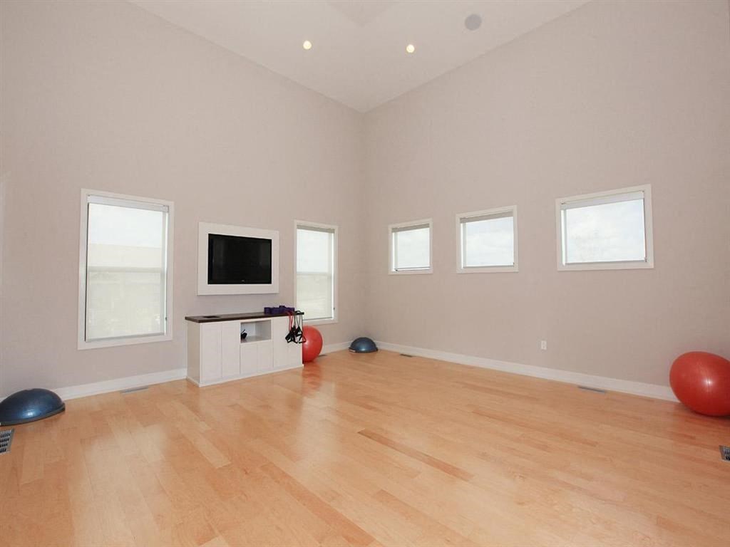 a living room with a tv and a hard wood floor