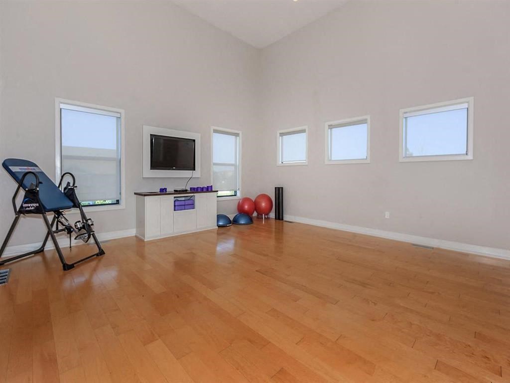 a living room with a wooden floor and a television