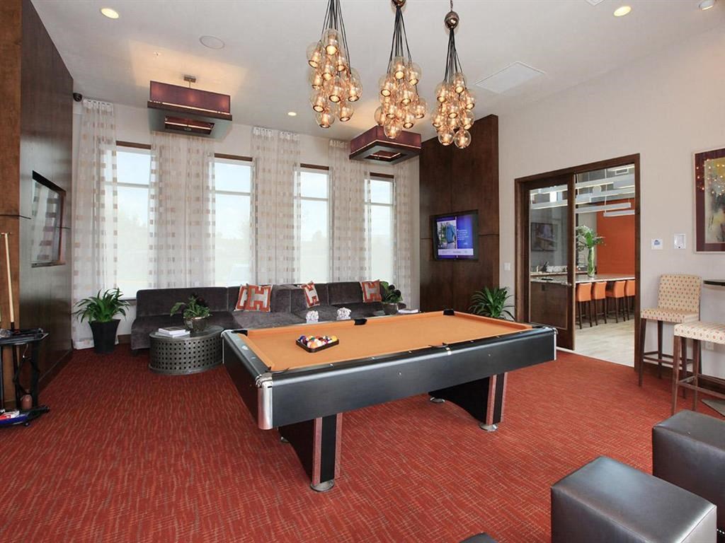 a game room with a pool table and a tv