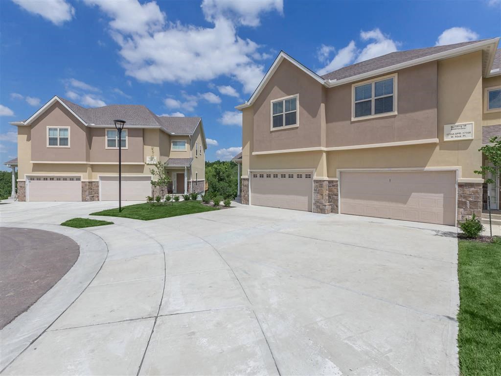 an empty driveway in front of a house