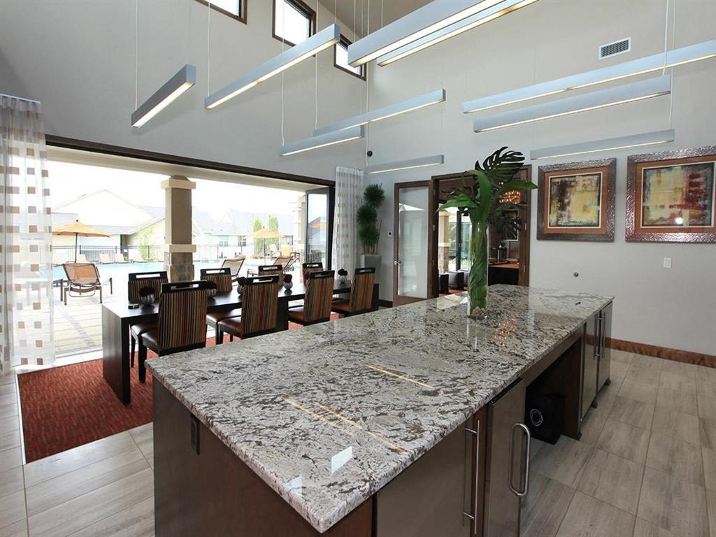 a large kitchen with a marble counter top