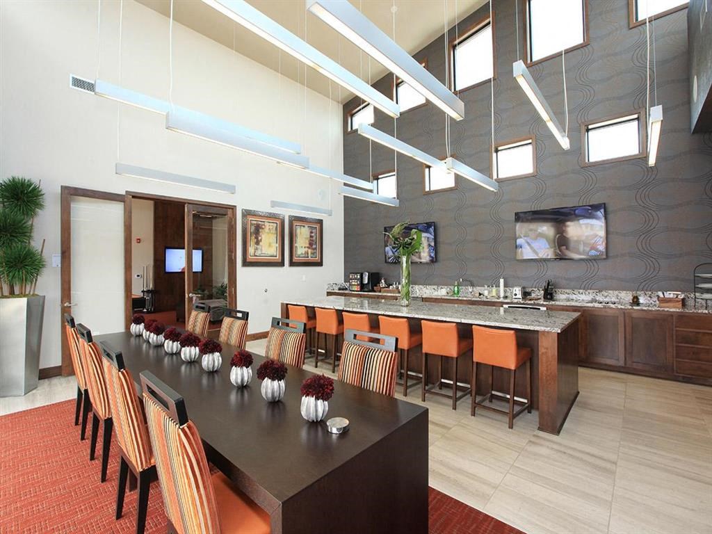 a dining room with a long table and chairs