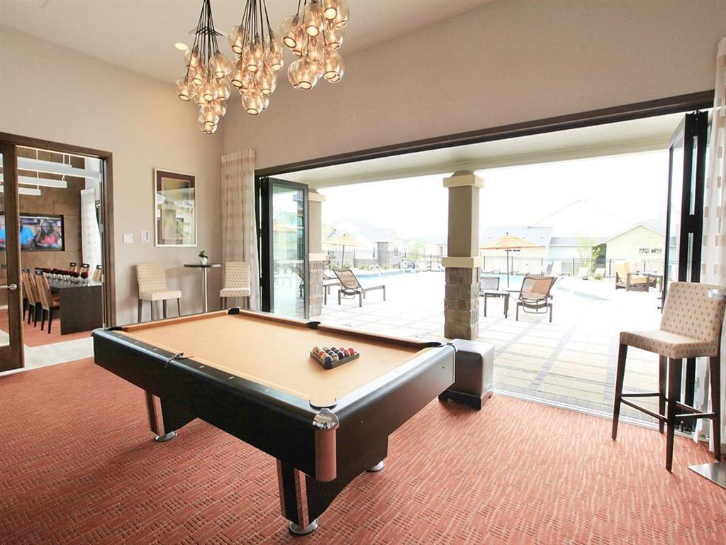 a pool table in a living room with a patio